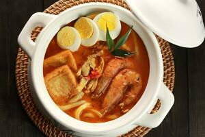 Curry Laksa which is a popular traditional spicy noodle or udon soup from the culture in Malaysia photo