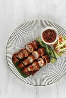 baked squids with chili called cumi bakar bumbu sambal or grill jumbo sotong photo