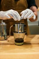 Vietnam Style Drip Coffee with Condensed Milk at the Bottom to Add Sweetness, Close Up photo