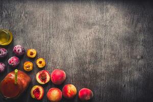 Peach and plums fruits smoothie in glass bottle and straws on wooden table. Healthy lifestyle. Toned photo