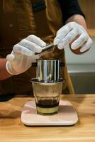 Vietnam Style Drip Coffee with Condensed Milk at the Bottom to Add Sweetness, Close Up photo