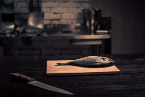Fresh fish on a wooden cutting board photo