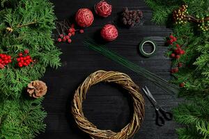 Manufacturer of Christmas decor with their own hands. Christmas wreath for the holiday. The new year celebration. Top view photo