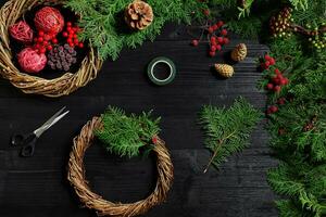 Manufacturer of Christmas decor with their own hands. Christmas wreath for the holiday. The new year celebration. Top view photo