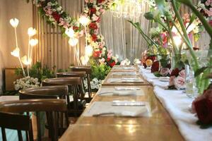 wedding altar and row of brown and white chairs shot at low angle prepared on the beautiful park or garden photo