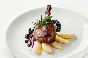 Food. Duck leg with pear and currant sauce. Delicatessen Gourmet Restaurant Menu Concept photo