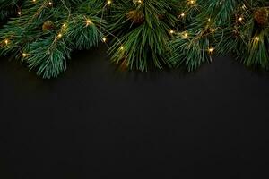 Christmas. Xmas toys and spruce branch on black background top view. Space for text photo