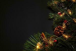 Christmas. Xmas toys and spruce branch on black background top view. Space for text photo