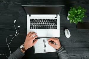 Directly above view of human hands typing on laptop. photo