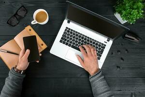 Directly above view of human hands typing on laptop. photo