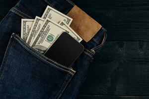 Cash and smart in your jeans pocket. Still life. photo