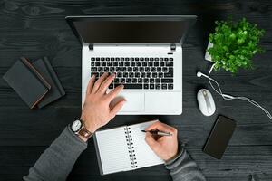 Directly above view of human hands typing on laptop. photo