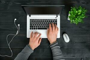 Directly above view of human hands typing on laptop. photo