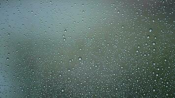 Raindrops in a window a raining day while it's raining outside video