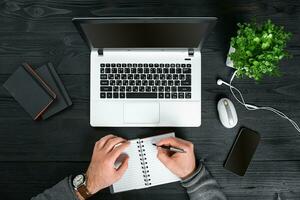 Directly above view of human hands typing on laptop. photo