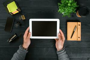 Directly above view of human hands with digital tablet. photo