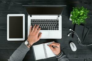 Directly above view of human hands typing on laptop. photo