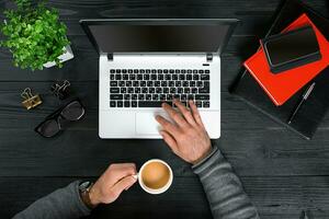 Directly above view of human hands typing on laptop. photo