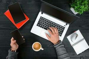 Directly above view of human hands typing on laptop. photo