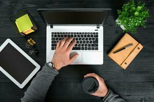 Directly above view of human hands typing on laptop. photo