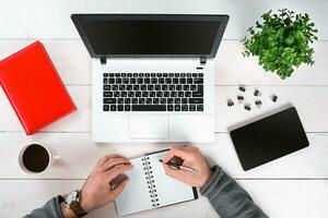 Directly above view of human hands typing on laptop. photo