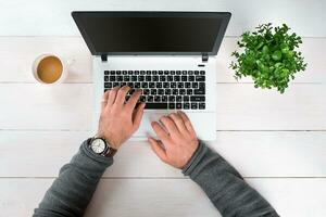 Directly above view of human hands typing on laptop. photo