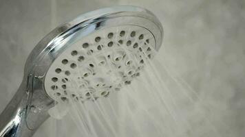 Shower faucet open expelling water in a bath video