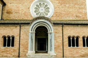 the entrance to a church with a large window photo