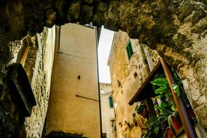 a narrow alley with a stone archway in it photo