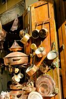 a shop with many copper pots and pans photo
