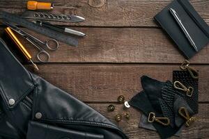 Leather products. Work place craftsman in a workshop. Top view photo