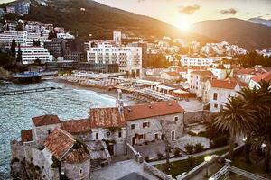 Red roofs of Budva in Montenegro. Sun flare photo