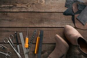 Leather products. Work place craftsman in a workshop. Top view photo