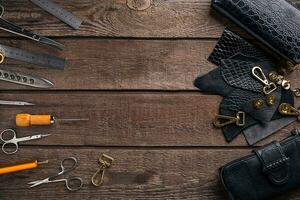 Leather products. Work place craftsman in a workshop. Top view photo