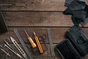 Leather products. Work place craftsman in a workshop. Top view photo