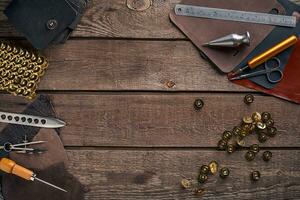 Leather handbag. Work place craftsman in a workshop. Top view photo