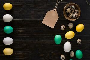 Greeting card with paschal eggs on rustic, wood table photo