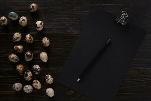 quail eggs, place for text on wooden rustic background top view close up photo
