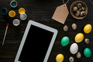 Greeting card with paschal eggs on rustic, wood table photo