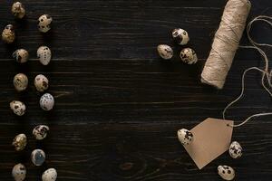 quail eggs, place for text on wooden rustic background top view close up photo