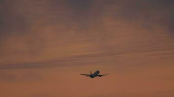 Footage of airplane flies, take off at night. Passenger plane departure at sunset. Flight leaving. Tourism and travel concept video