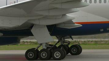 Passenger plane taxiing, closeup. Side view of chassis and porthole video