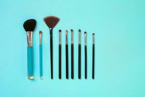 Make up essentials. Set of professional make up brushes on blue background. photo