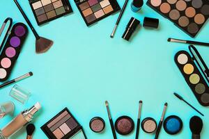 Various cosmetics and brushes on blue background photo