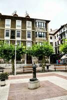 a fountain in the center of a town square photo