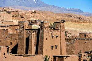 city in morocco with the snow capped mountain in the background photo