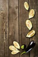 sliced eggplant on slate and wooden counter top background photo