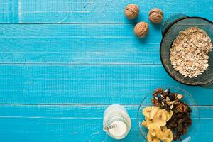 Porridge, oats, milk and banana on the table photo