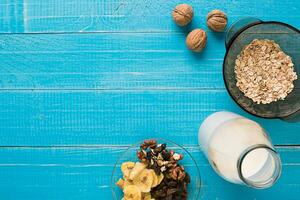 Porridge, oats, milk and banana on the table photo