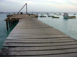 a wooden bridge over the water photo